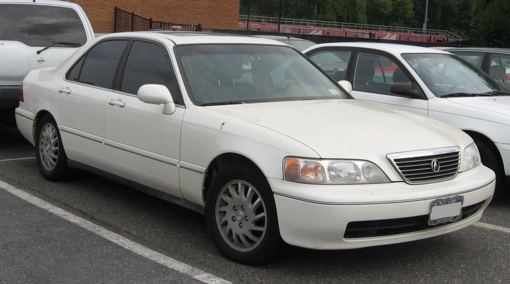 White sedan front-side view with grille and headlights