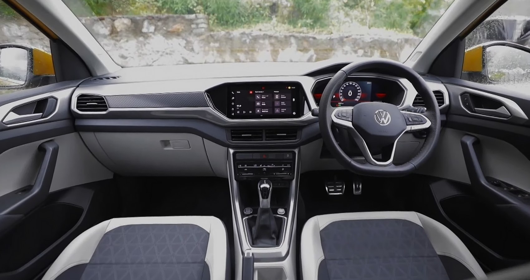 dashboard with digital cluster and infotainment screen, steering wheel, modern seats