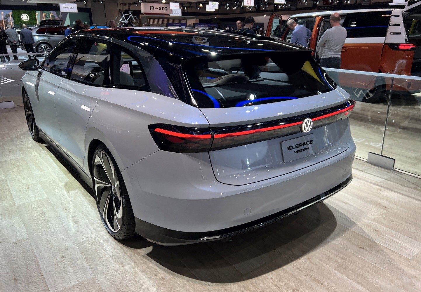 Rear view of a futuristic electric vehicle with sleek taillights and panoramic rear window.