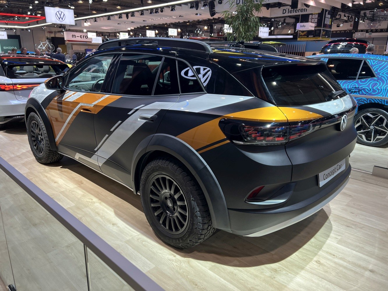 Rear side view with rugged off-road tires and bold angular paint design
