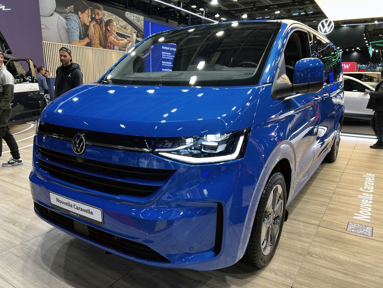 Blue van front with modern LED headlights and bold grille