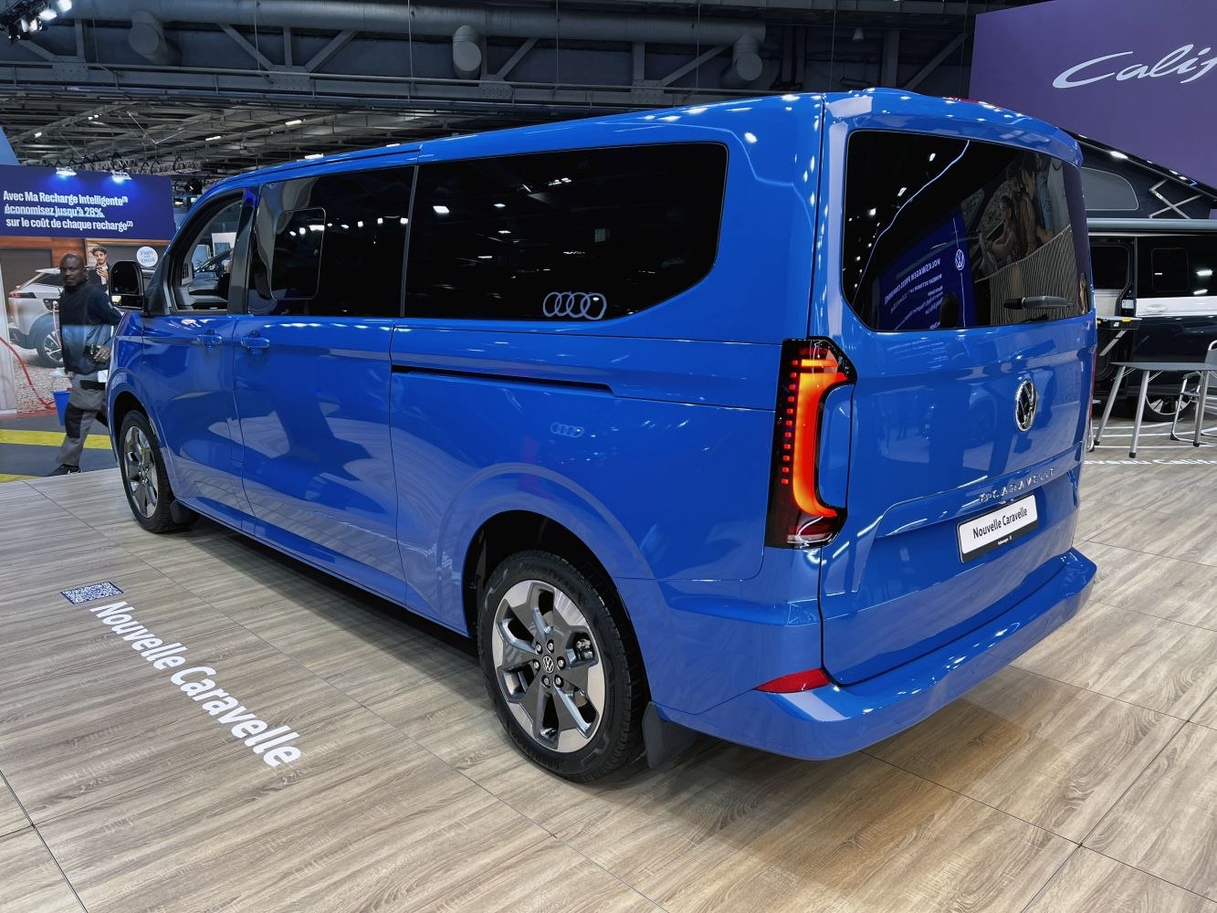 Rear and side view of blue long wheelbase van with modern taillights