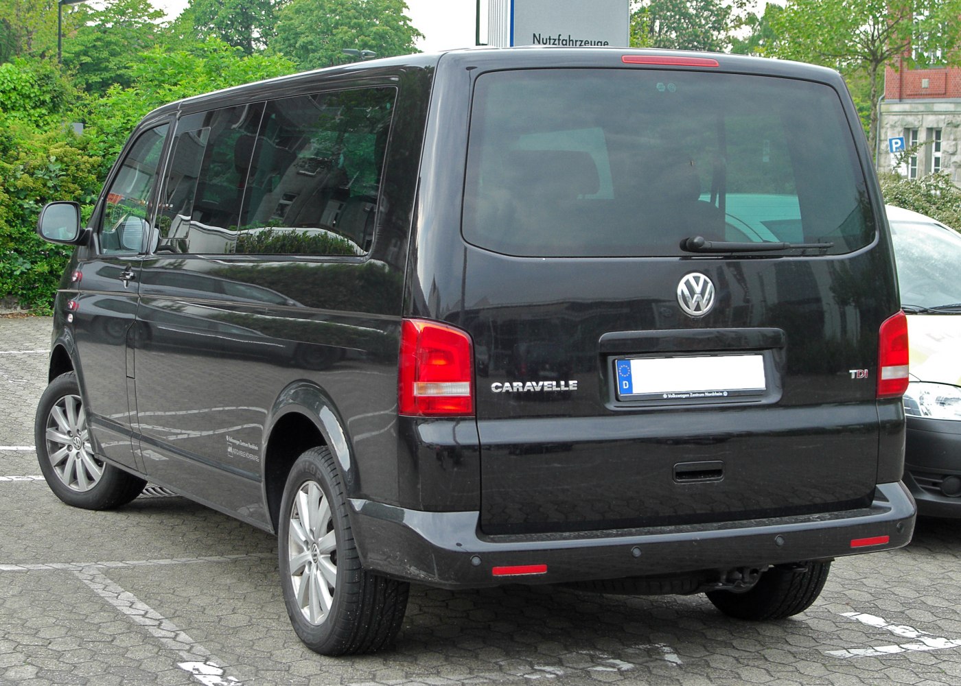 Black van rear view with tinted windows and red rear lights