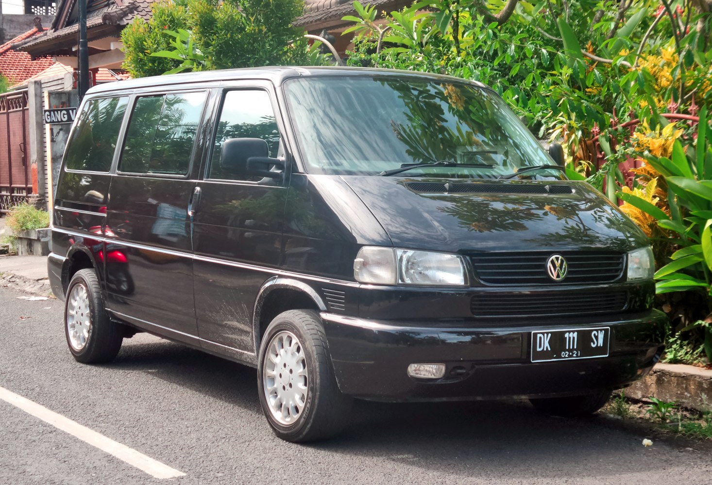 Front and side view of a black passenger van with large windows