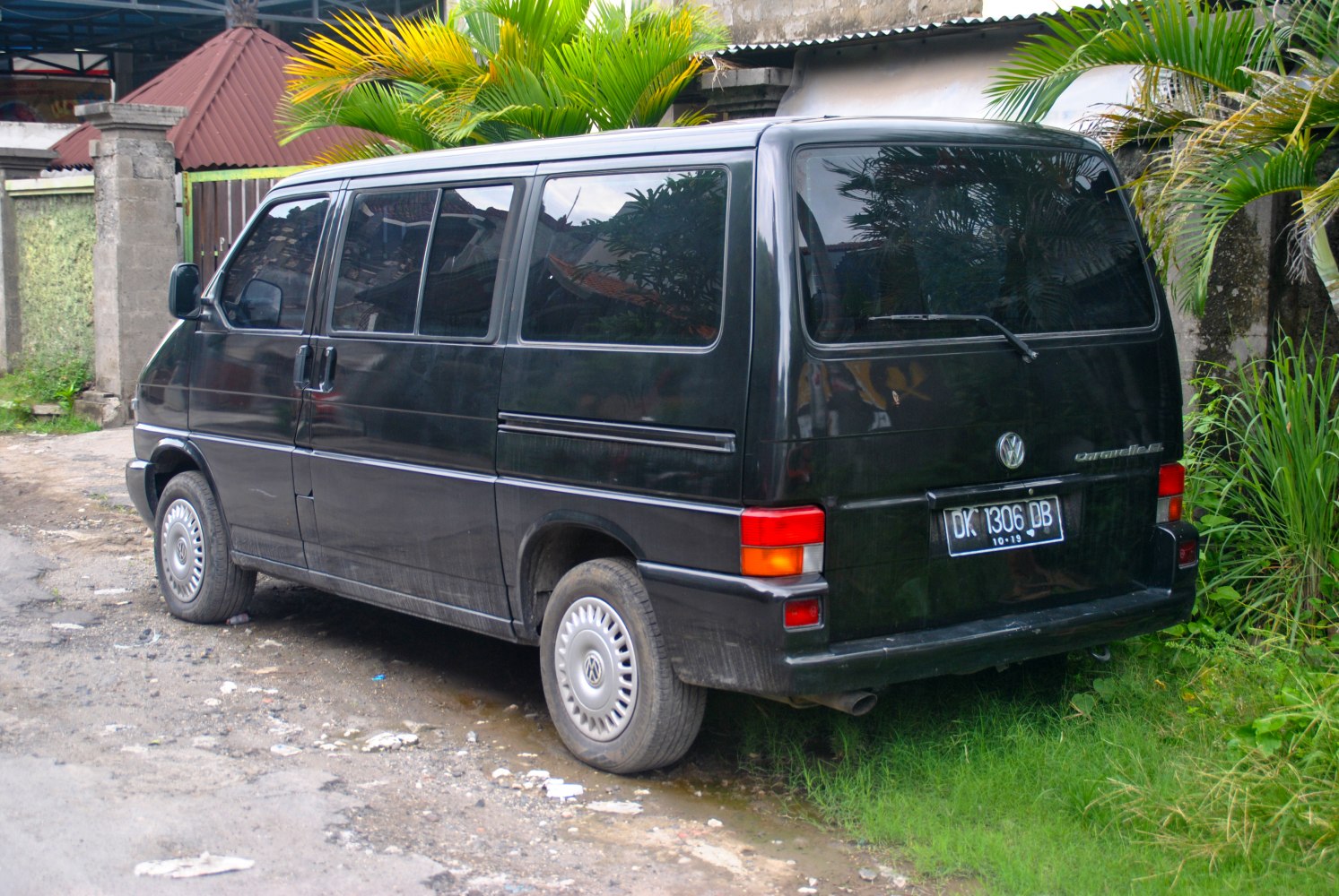 Rear view of black van with sliding door and tinted windows