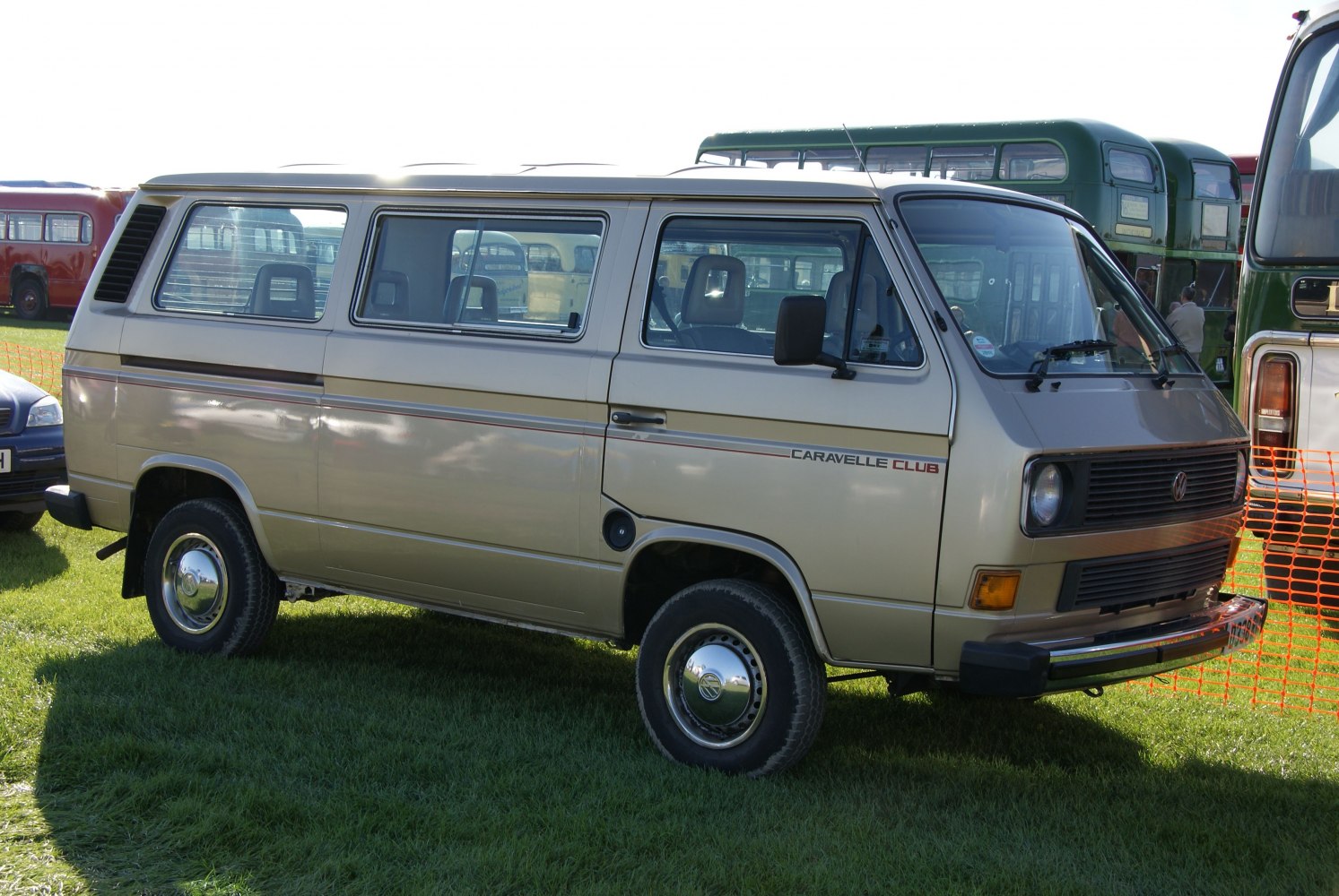 Boxy van side profile with tinted windows and vintage steel wheels