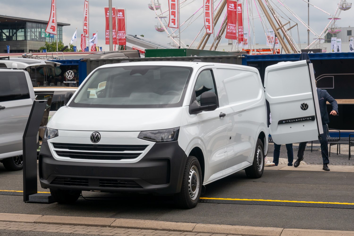 White panel van with rear open doors and black front bumper