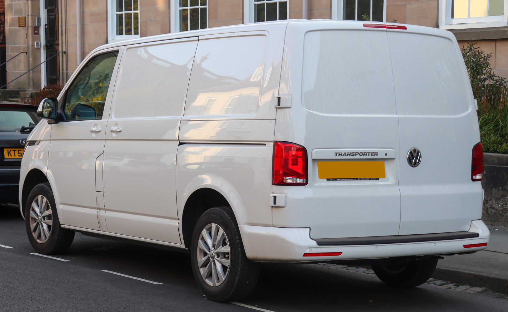 Rear view of a panel van with smooth cargo doors and red taillights