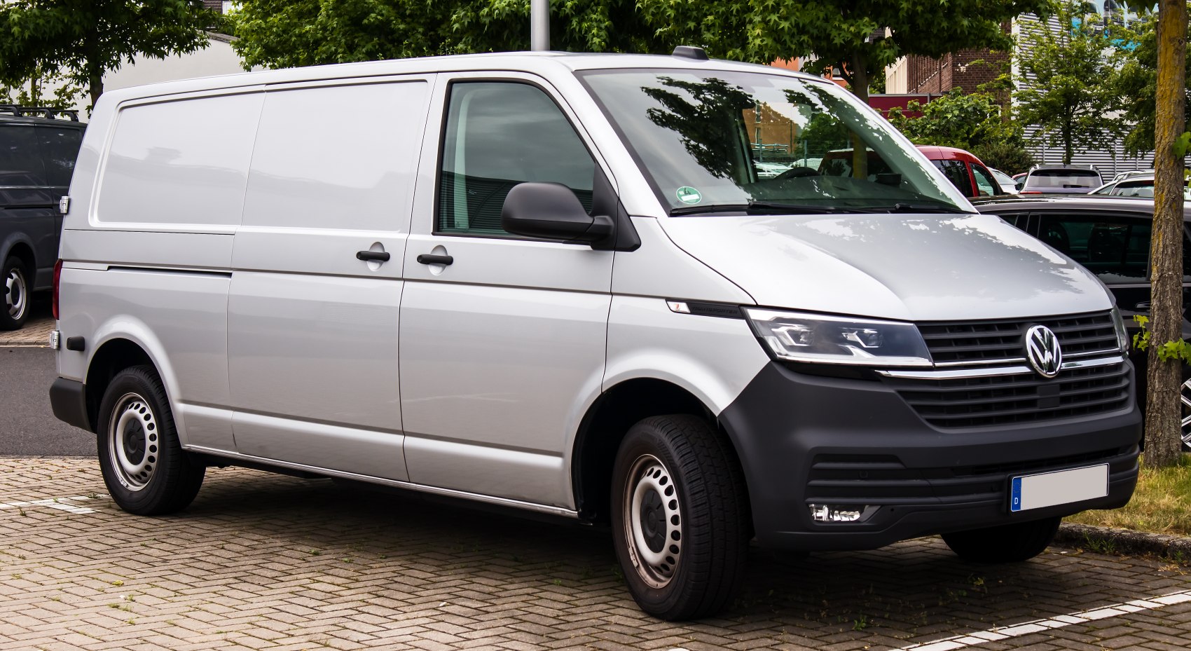 Silver panel van with modern headlights and black front grille