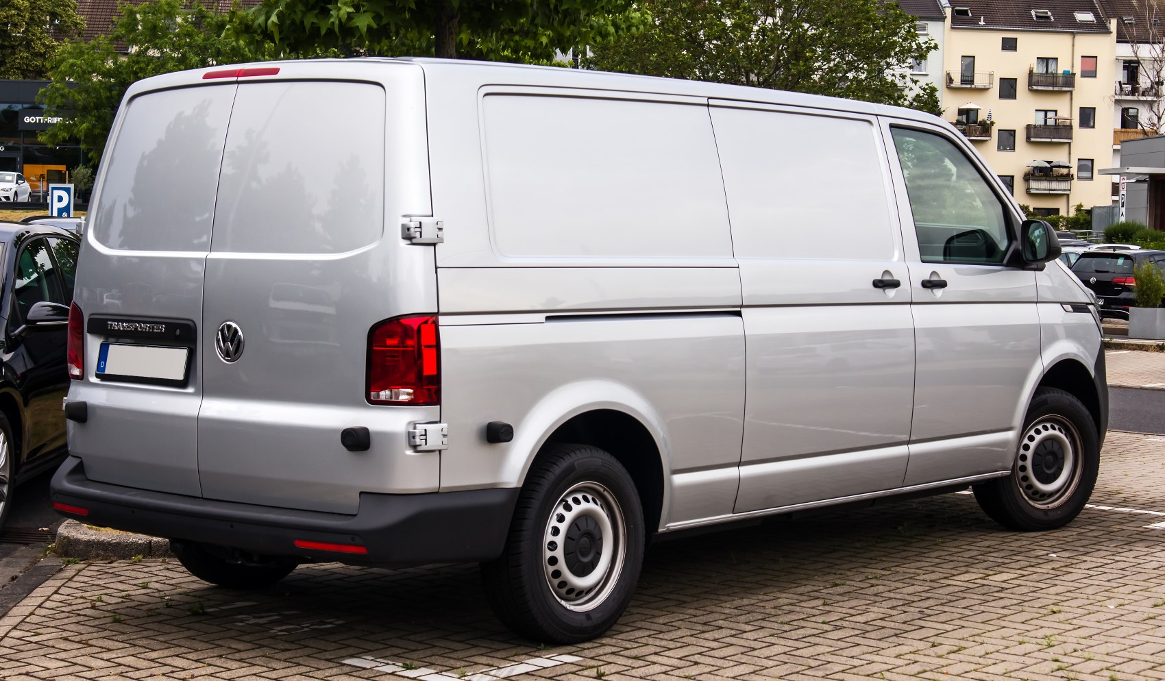 Side and rear of a panel van with barn doors and steel wheels