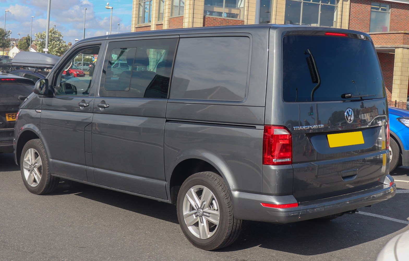 Rear-side profile of multipurpose van with dual cab and tinted windows