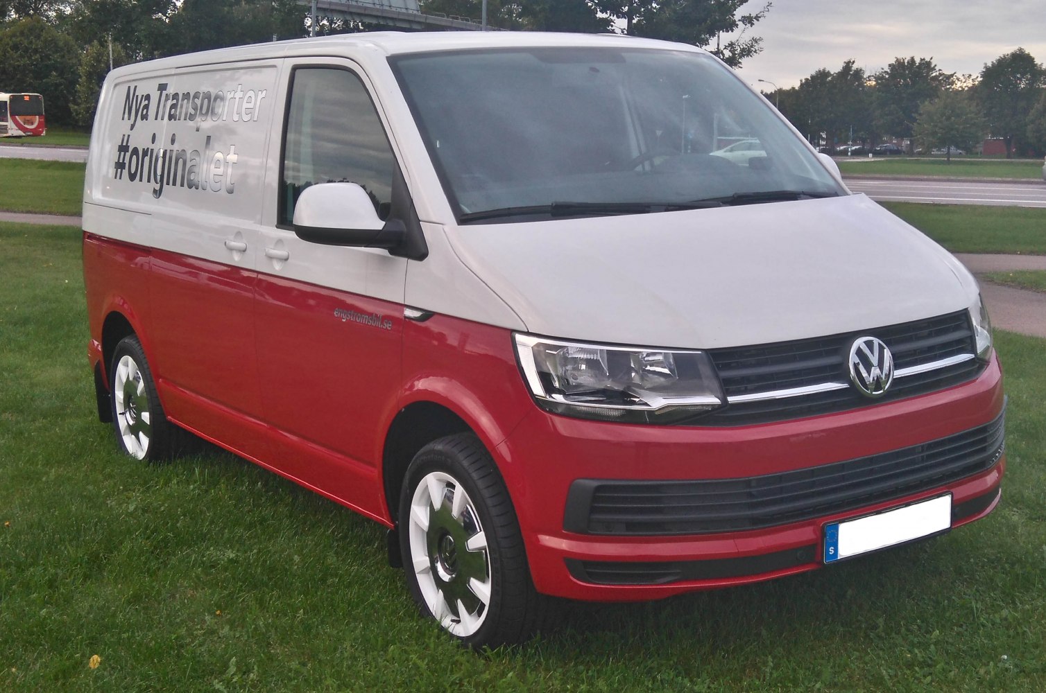 Two-tone red and white panel van with modern headlights