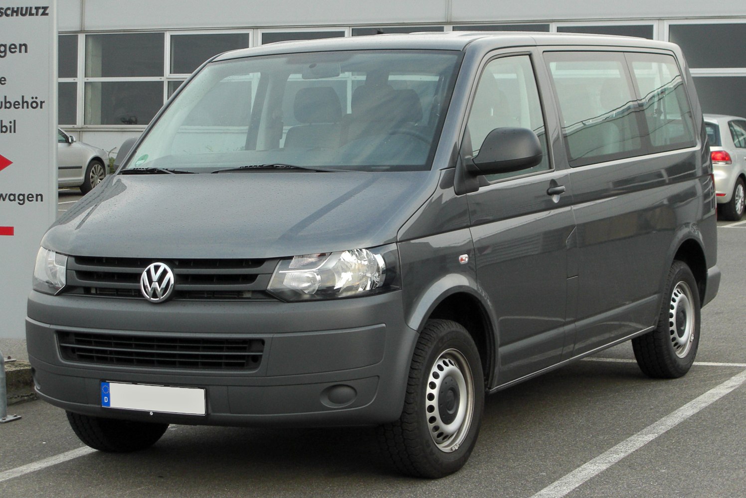 Front and side view of a van with rectangular headlights and steel wheels.