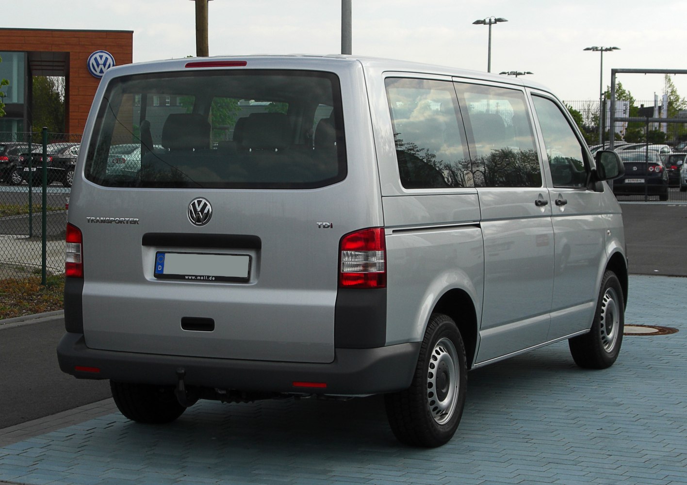 Rear view of a van with large windows and tail lights