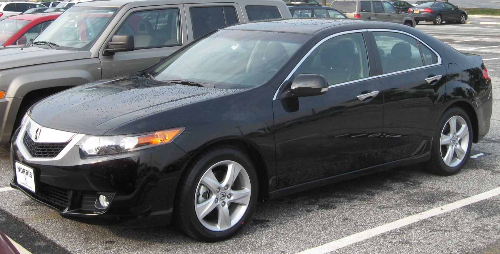 Black sedan with alloy wheels, fog lights, and sleek design