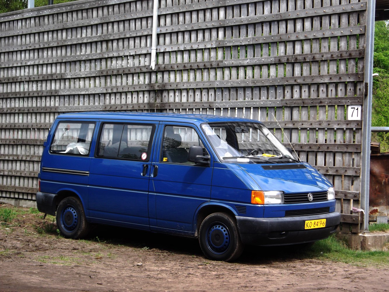Boxy blue van with sliding side door and rectangular headlights