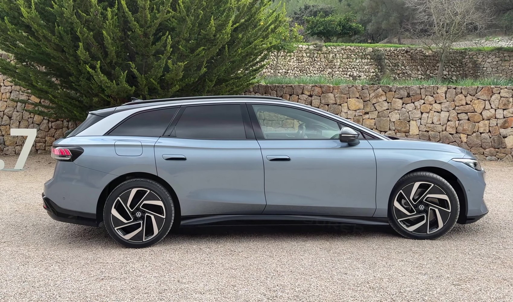 Side profile of an electric station wagon with aerodynamic design and modern wheels