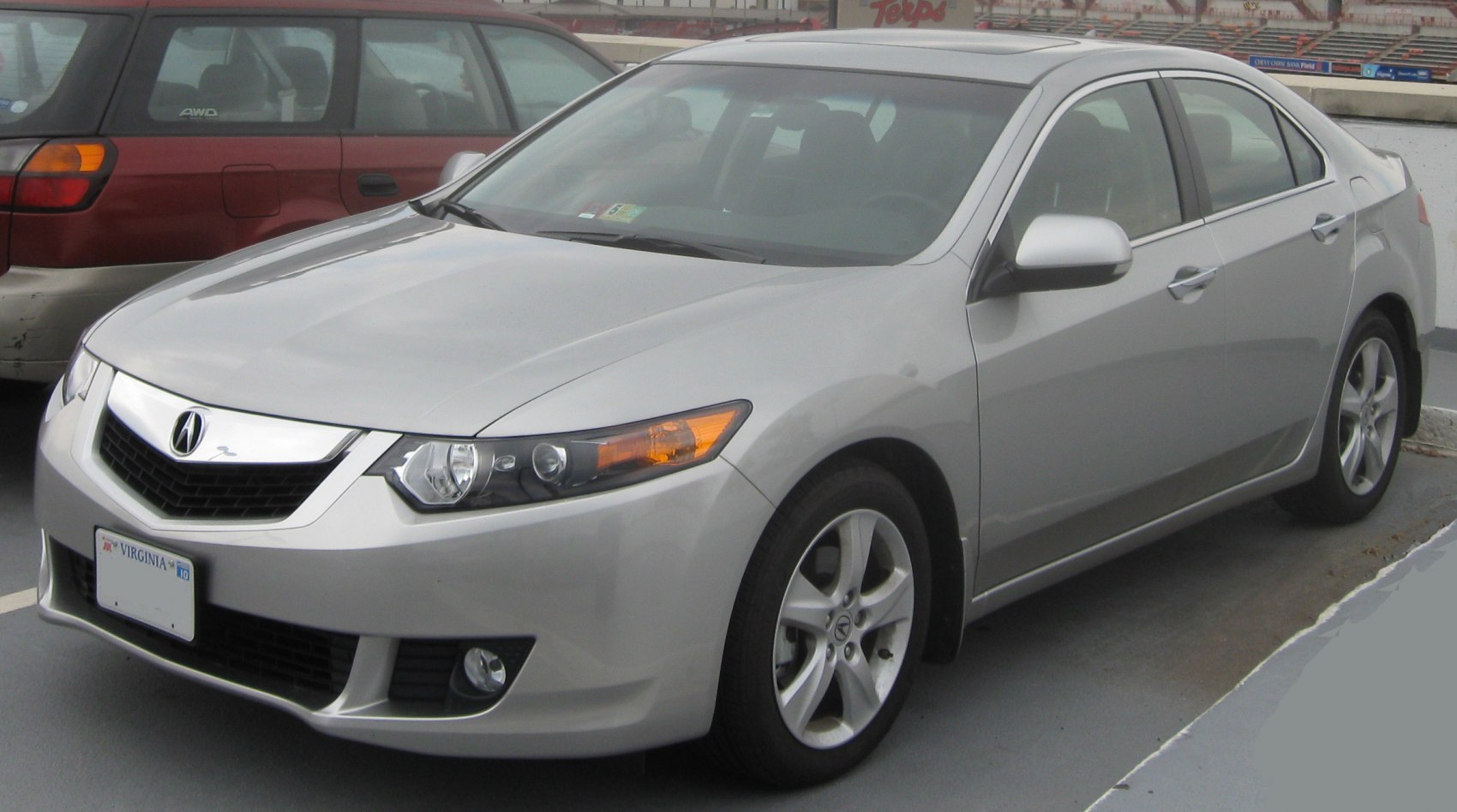 Silver sedan front-side view with distinct headlights and alloy wheels