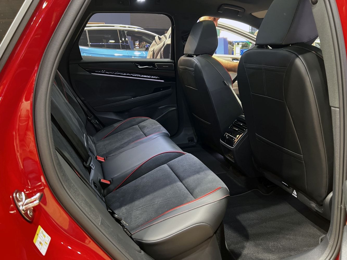 Rear seat interior with sporty black upholstery and red stitching