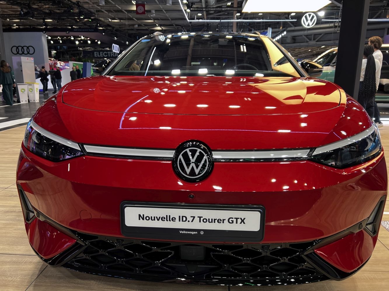 Front view of modern vehicle with sleek headlights and emblem
