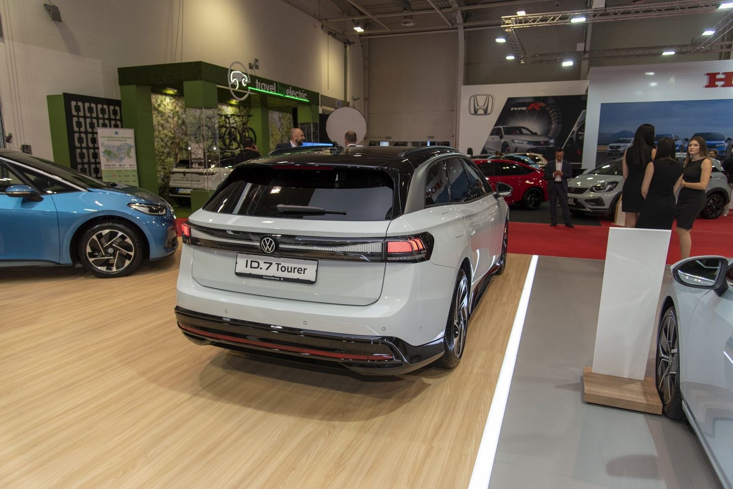 Rear view of a sleek, modern electric SUV with distinct taillights and black roof.