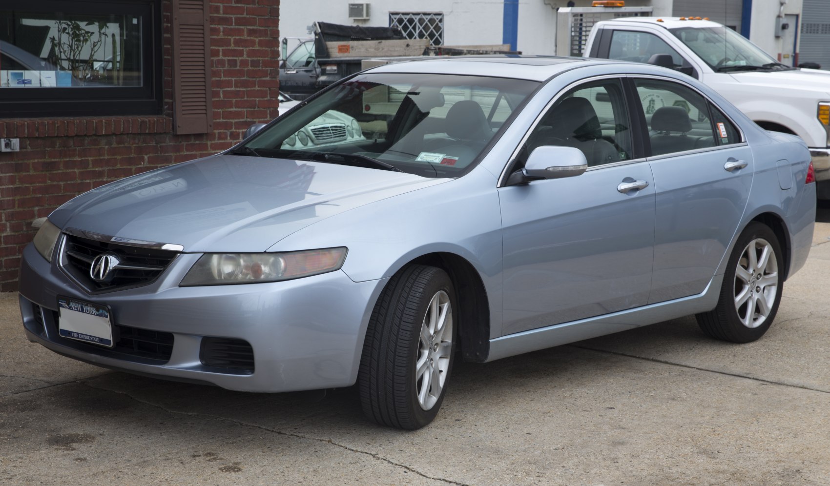 Front fascia and side profile of a silver sedan.