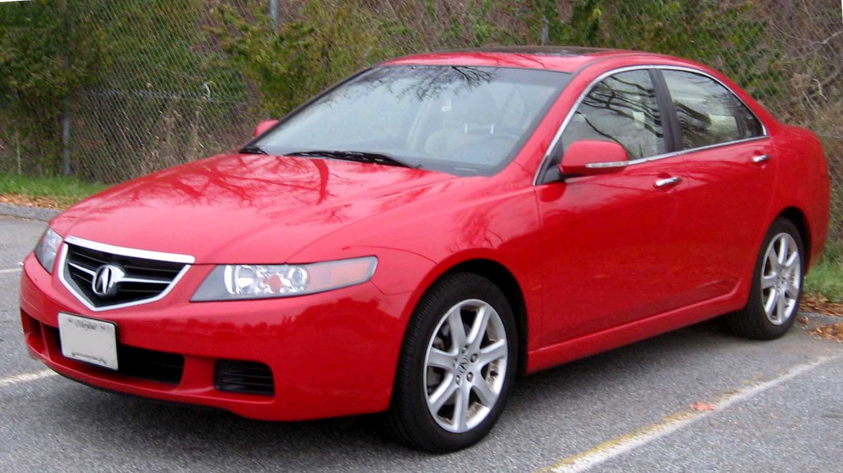 Red sports sedan with alloy wheels, front angled exterior view