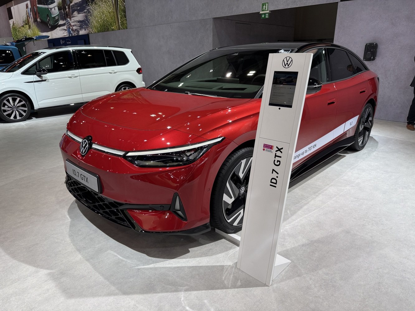 Red electric sedan front with sleek LED headlights and aerodynamic styling
