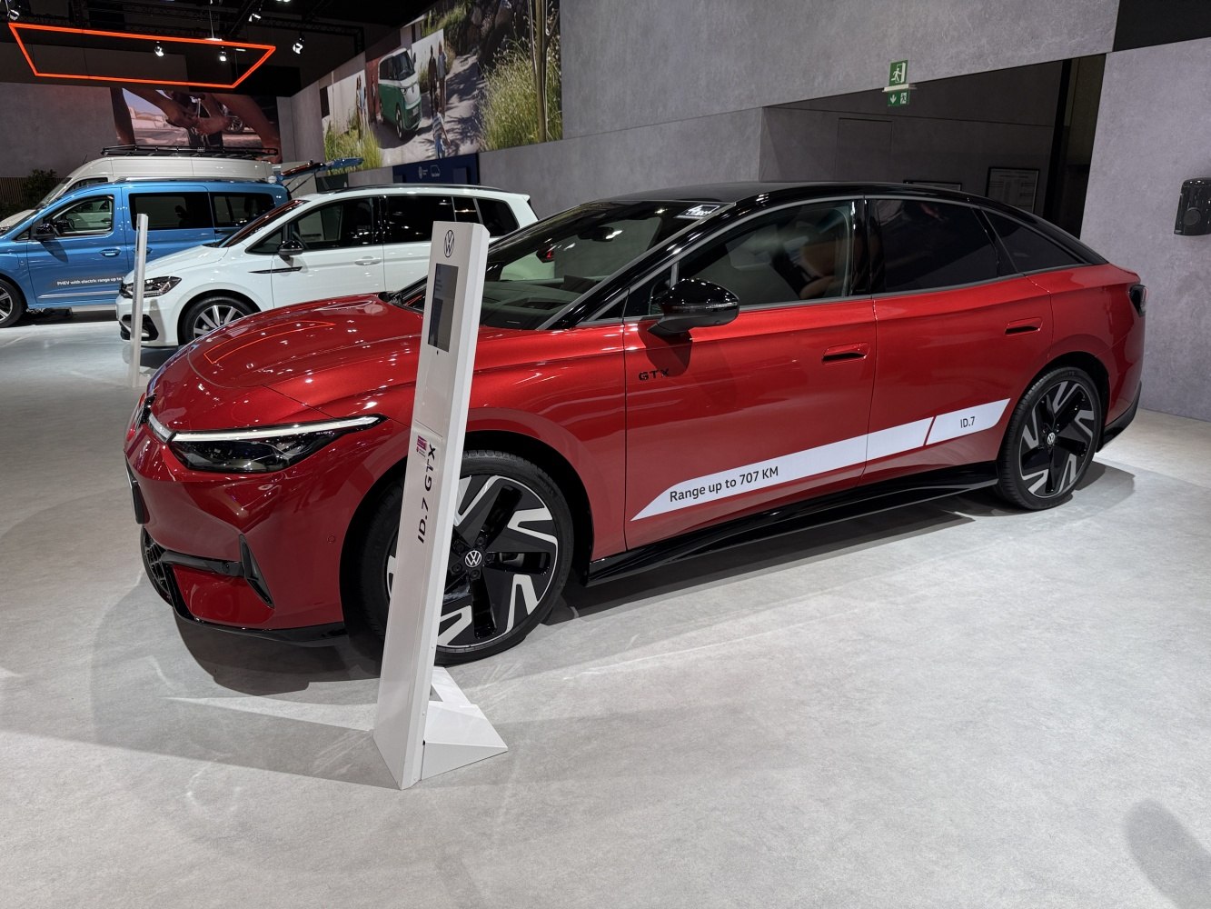 Red electric sedan with aerodynamic design and 707 KM range.