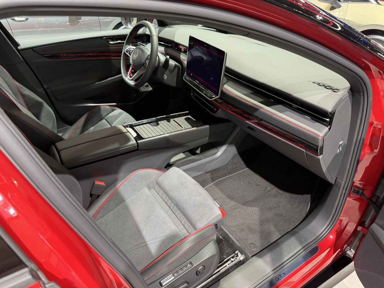 Digital cockpit and sporty seats with red stitching in modern car interior