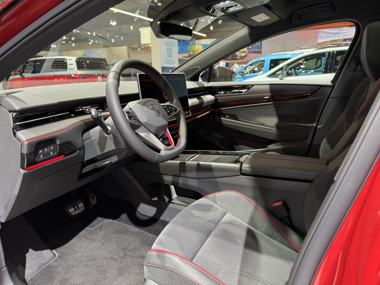 Modern digital dashboard and touchscreen with red-stitched seats