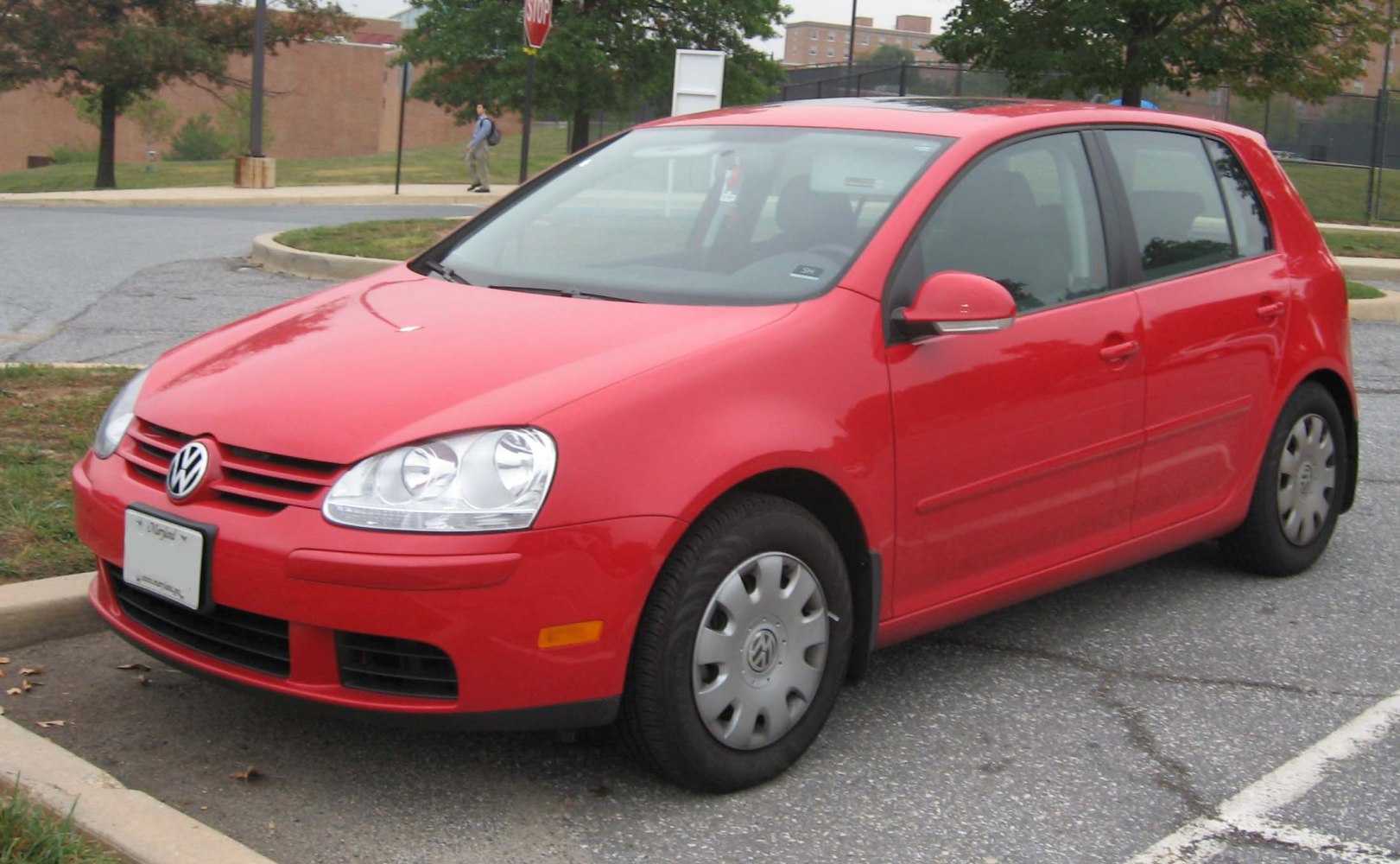 Red 5-door hatchback with prominent headlights and side profile