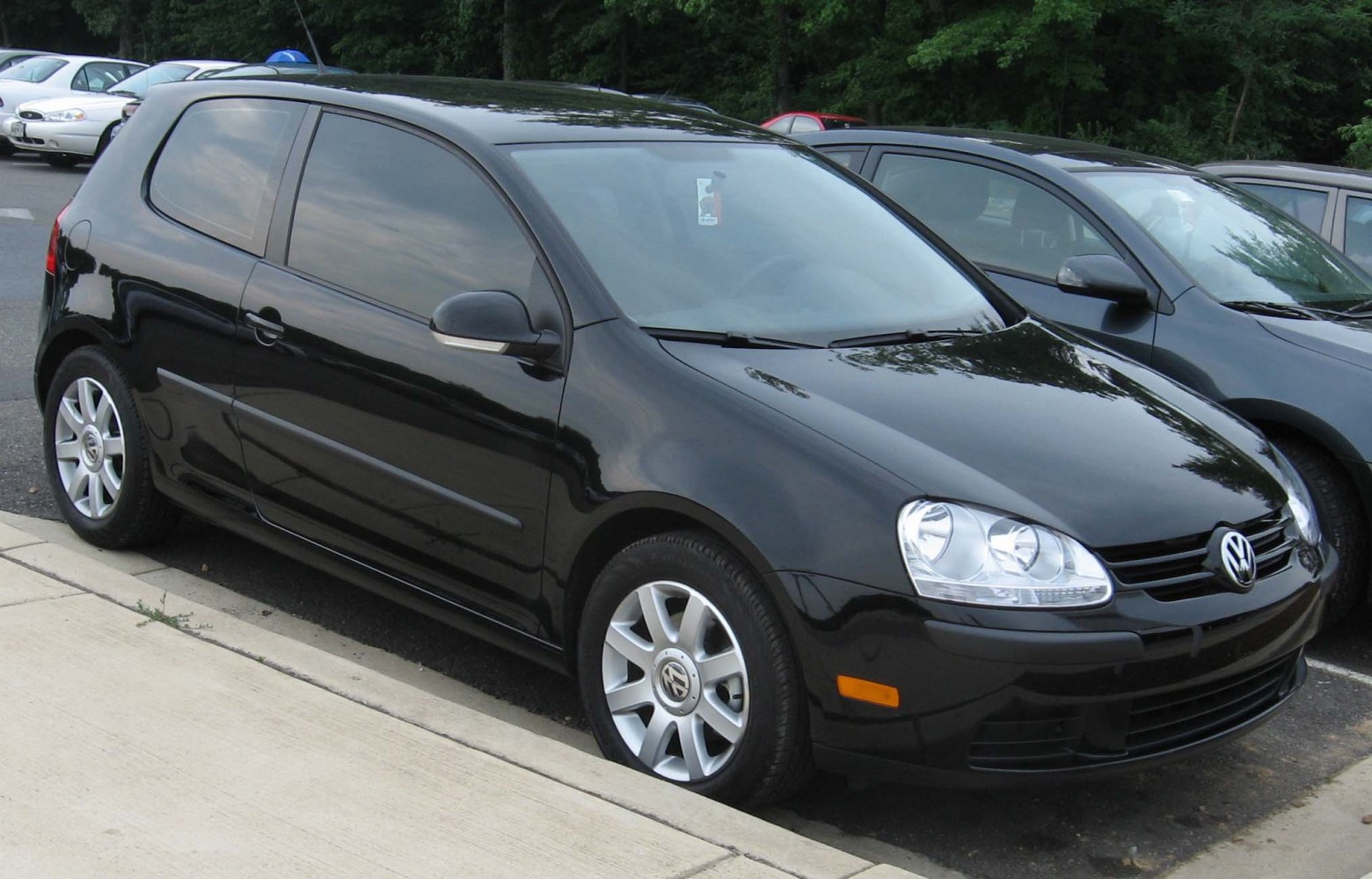 3-door hatchback with sleek black body and prominent headlights