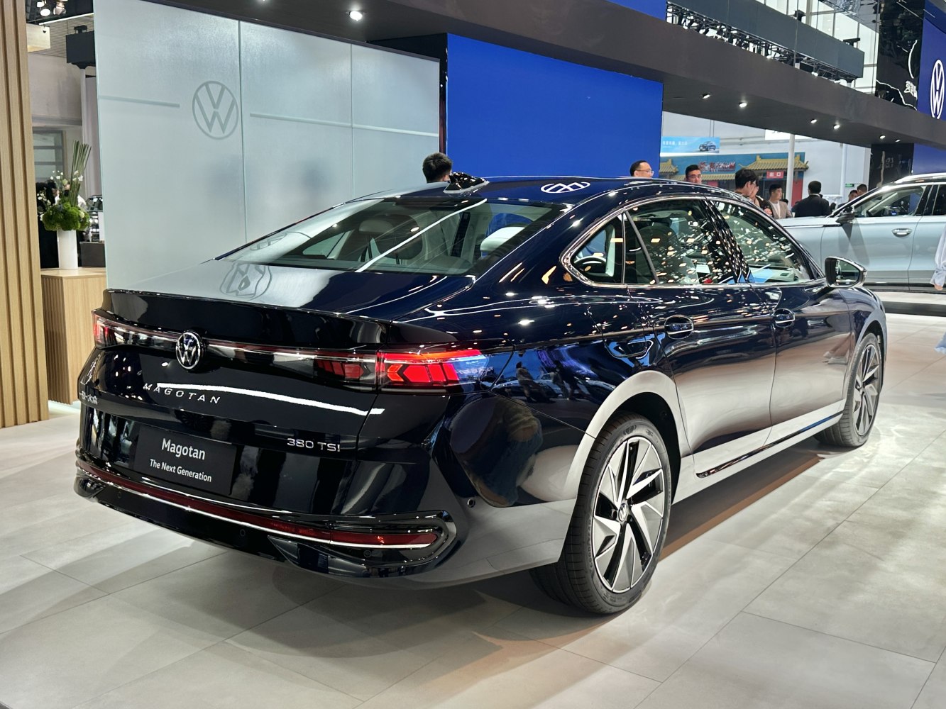 Sleek rear design and modern tail lights of a sedan at an auto show