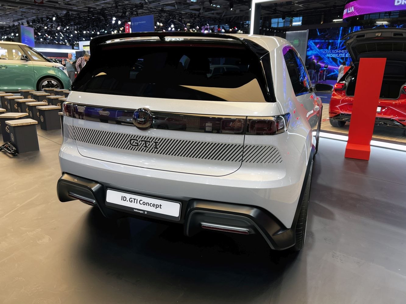 Rear view of futuristic electric hatchback with GTI badge and sporty elements.
