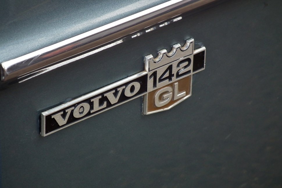 Close-up of a vintage Volvo 142 GL badge on car body