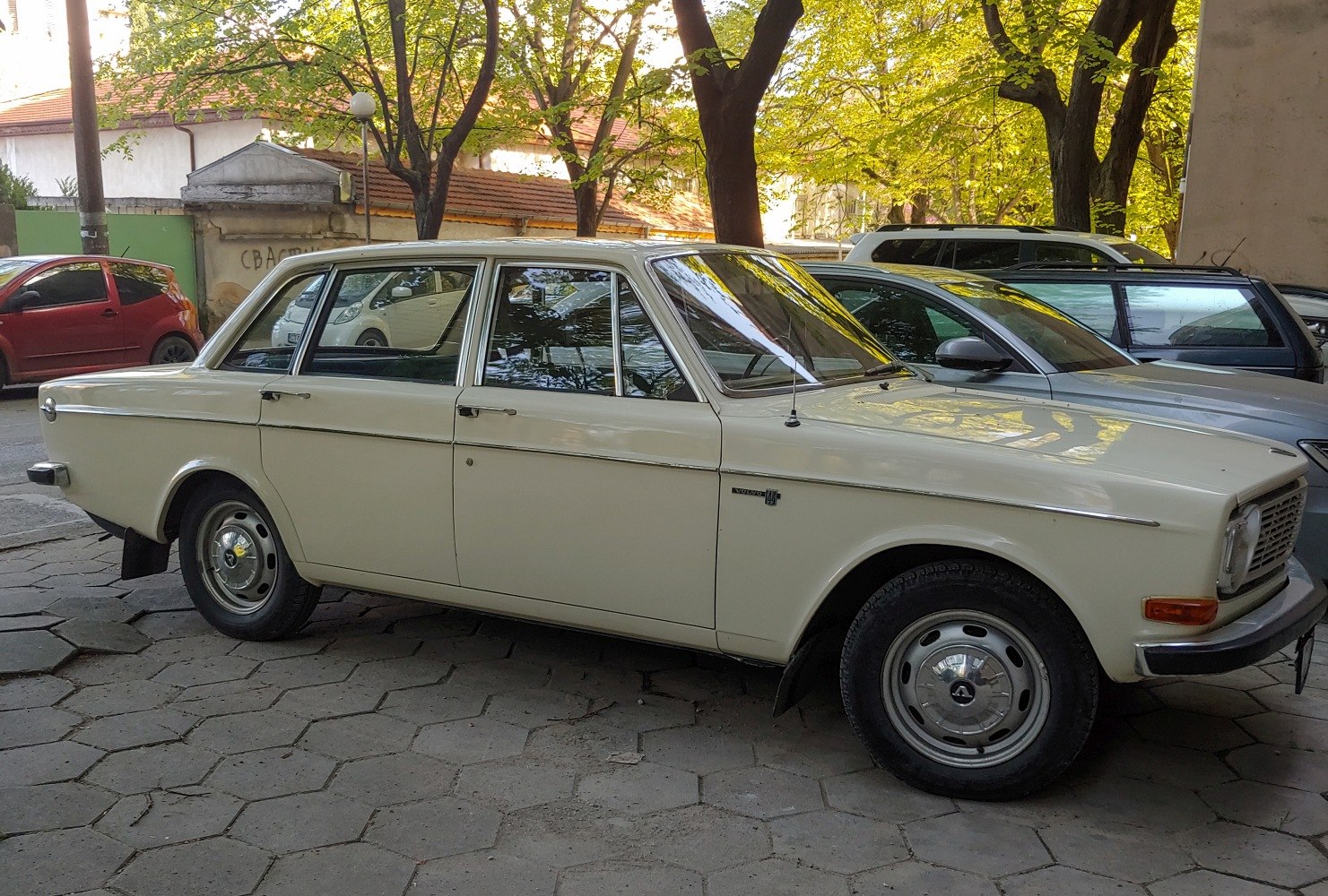 Vintage 1960s sedan with classic boxy design and chrome details.
