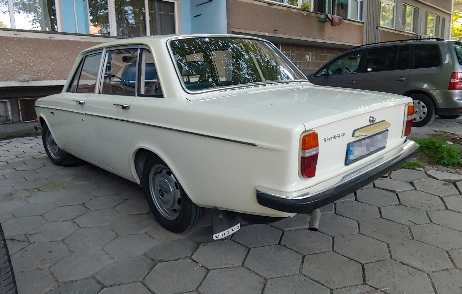 Rear view of classic 1960s sedan with distinct taillights and chrome bumper