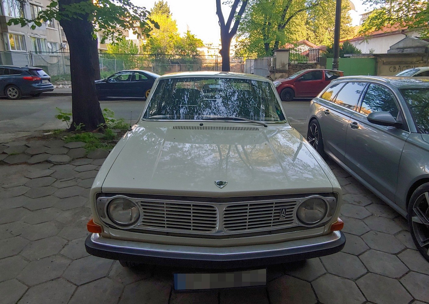 Classic vintage sedan front view with rectangular grille and round headlights.