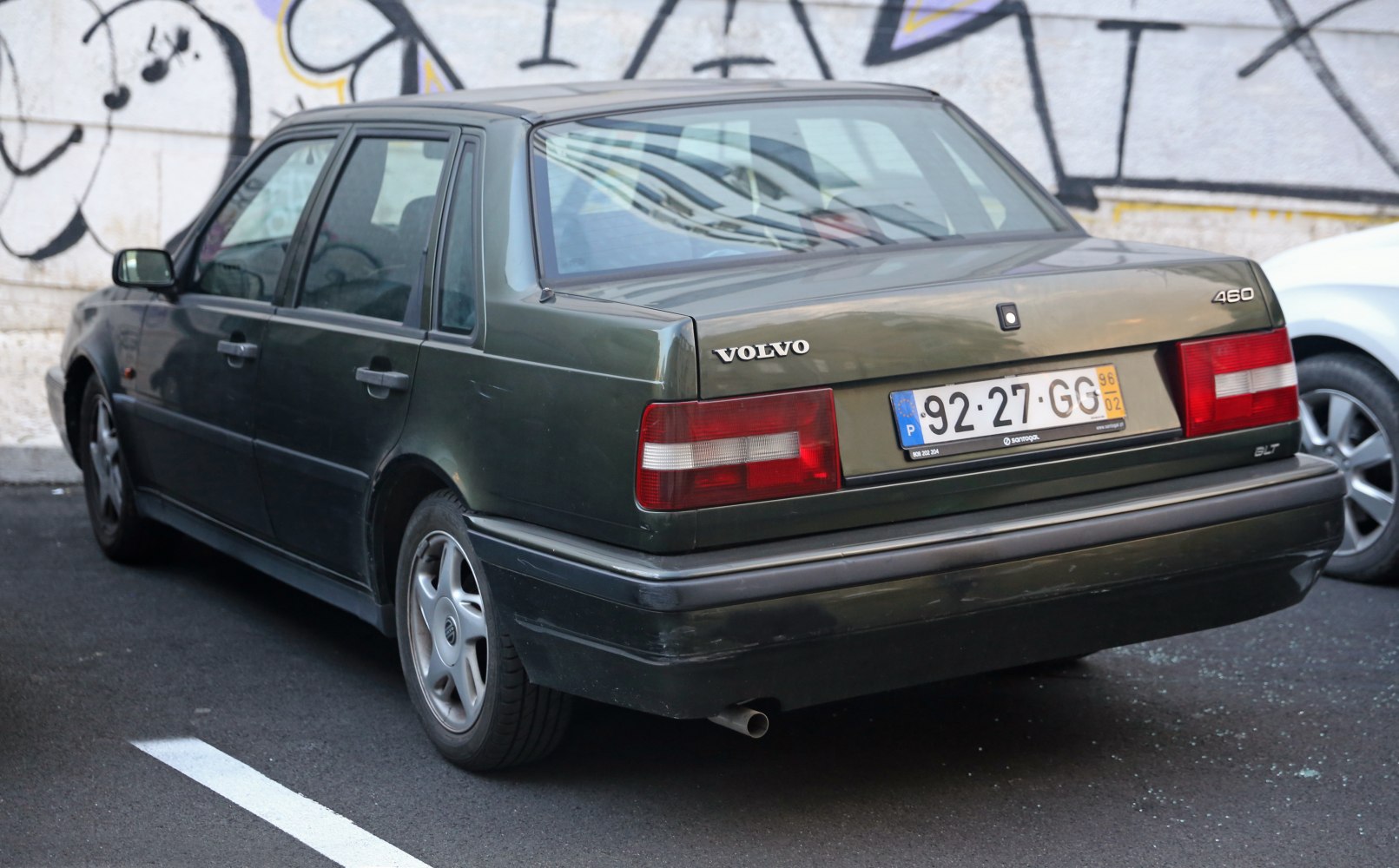 Boxy sedan rear with distinctive taillights and exhaust pipe