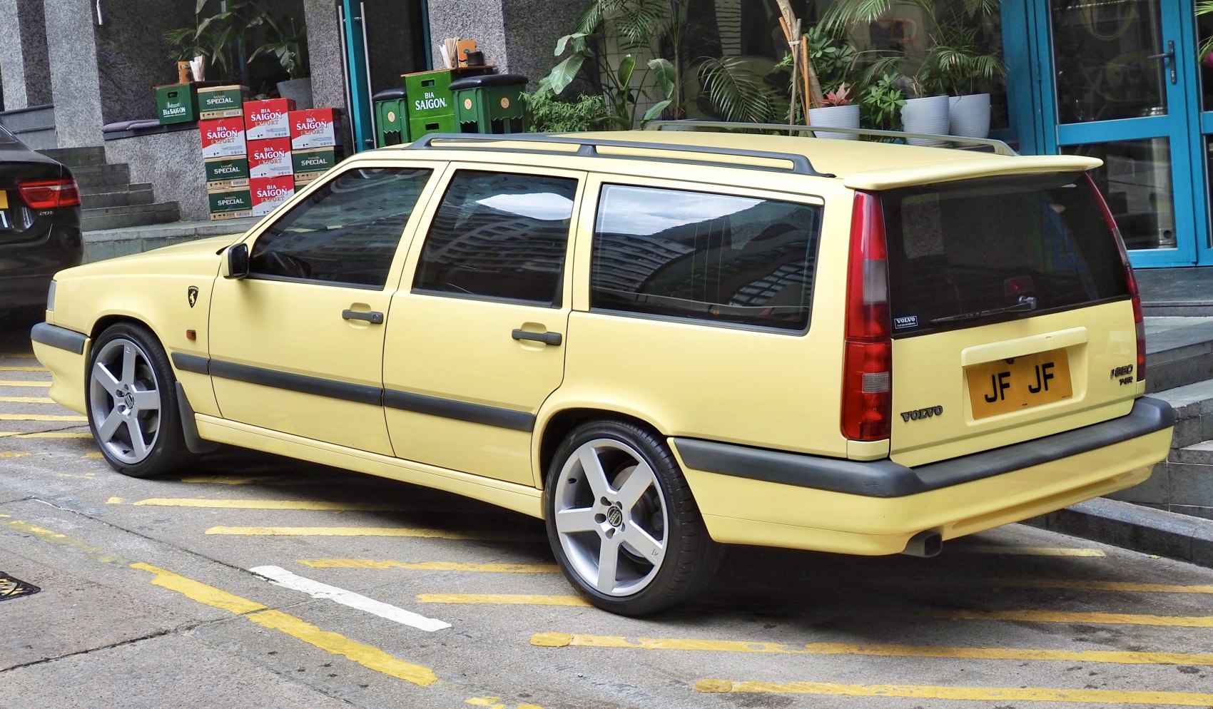 Yellow vintage station wagon with alloy wheels and roof rails