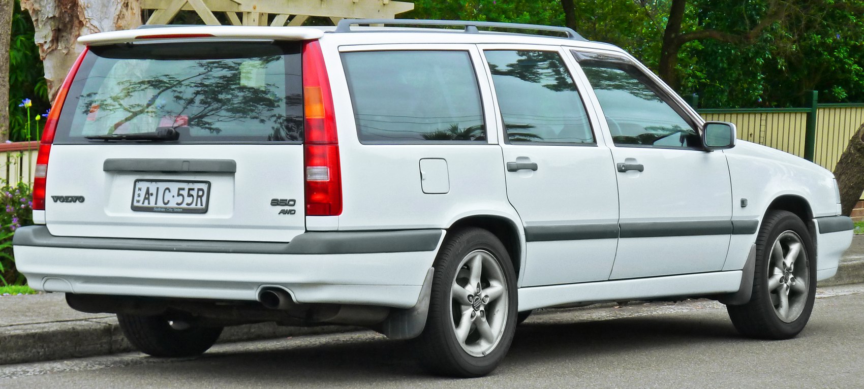 Rear and side view of station wagon with vertical tail lights and roof rails