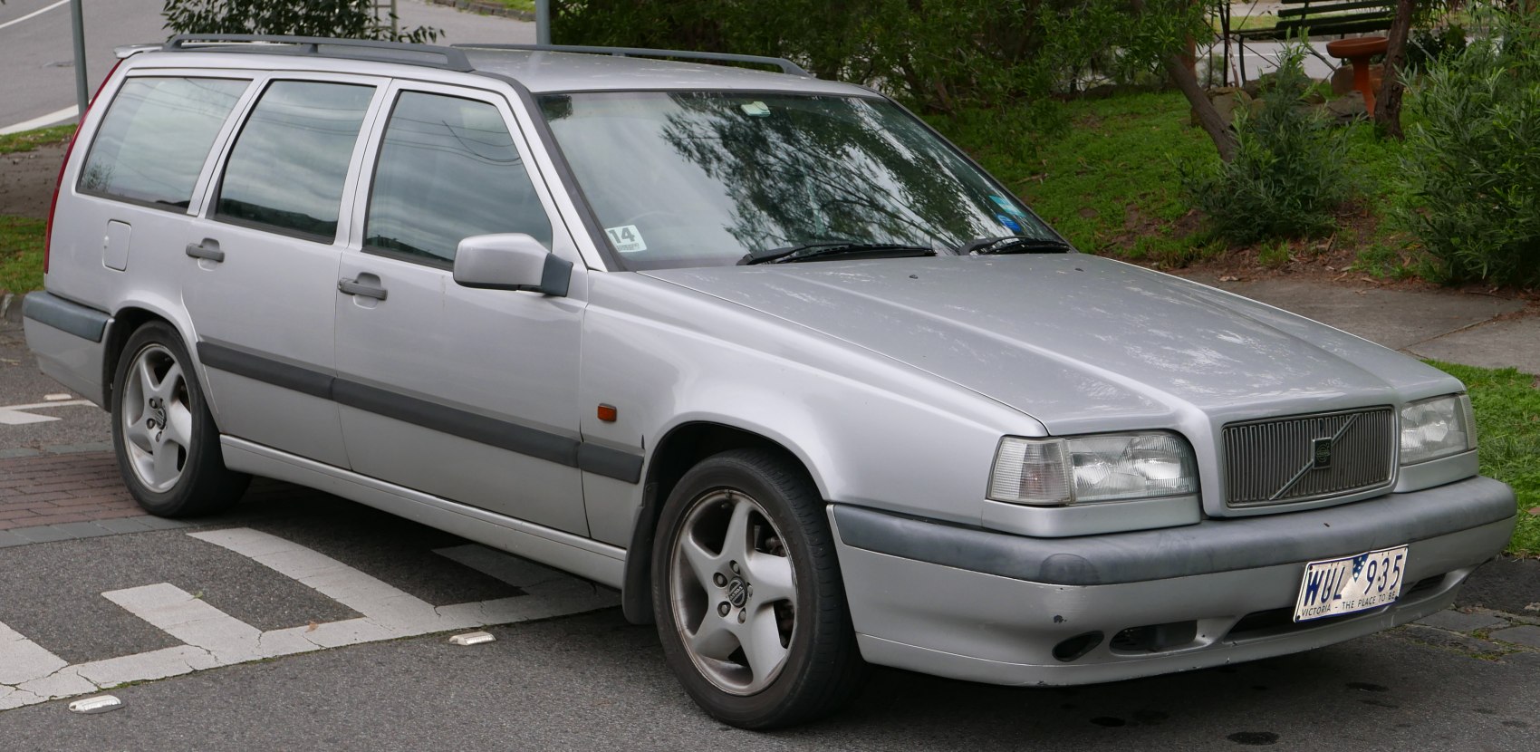 Front-side view of silver station wagon with alloy wheels and boxy design