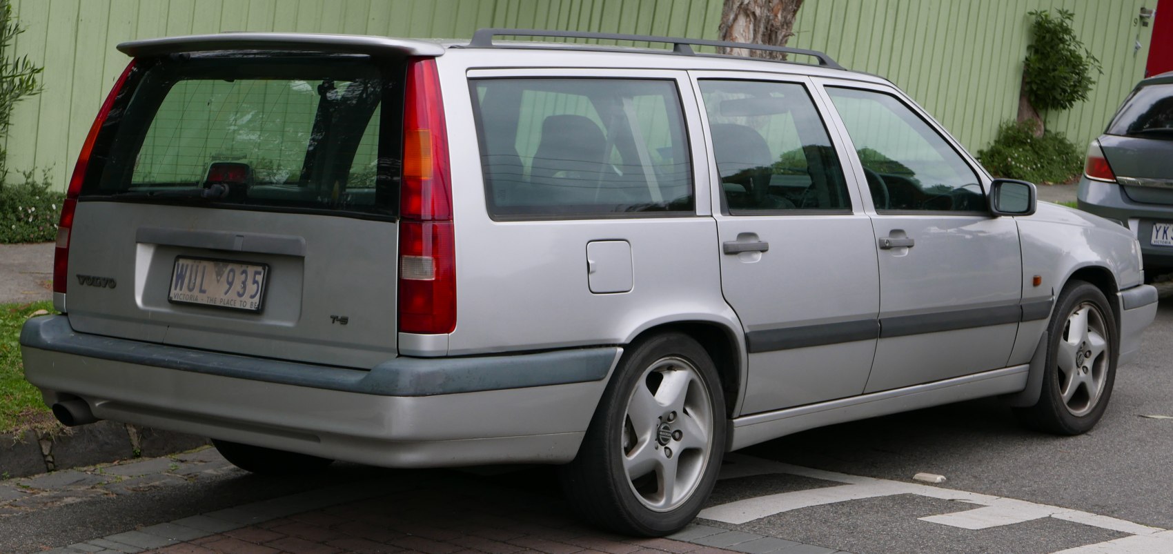 Silver station wagon rear side with vertical taillights and alloy wheels