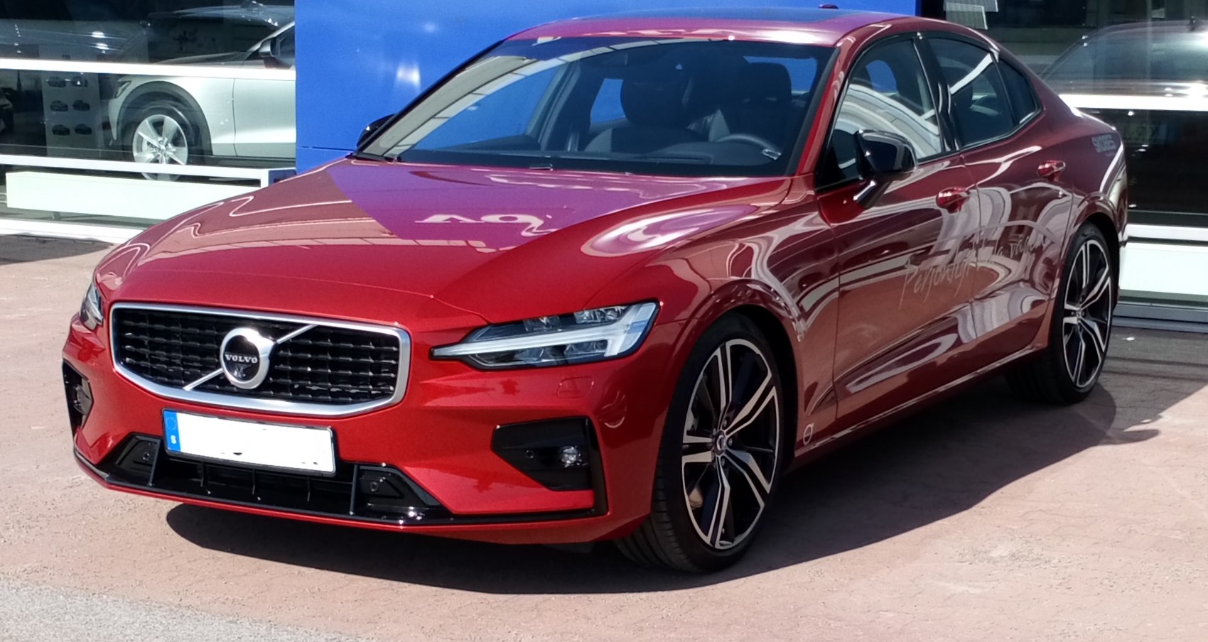 Red sedan front and side with LED headlights and alloy wheels