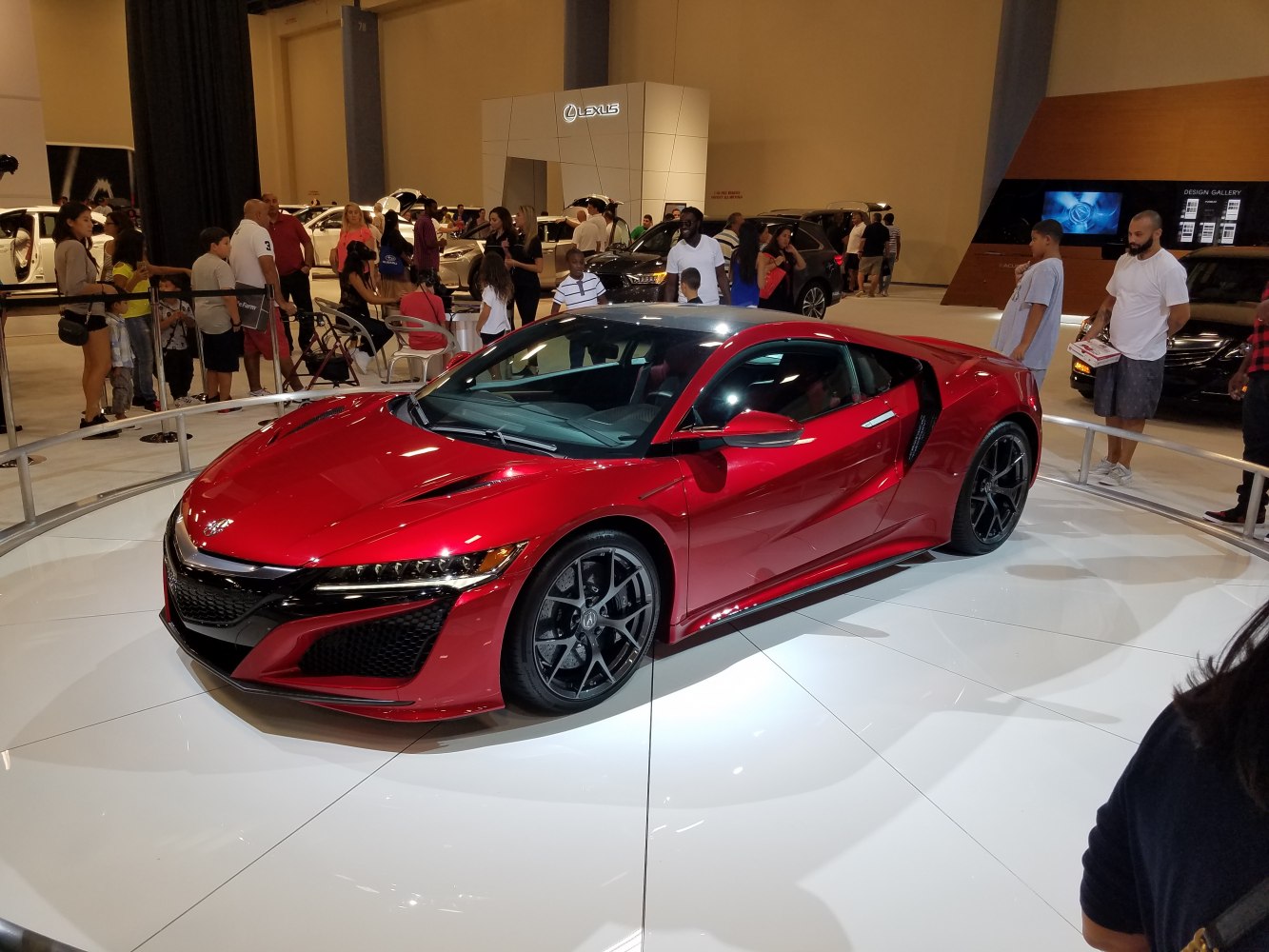 Red sports coupe with black alloy wheels and aerodynamic design