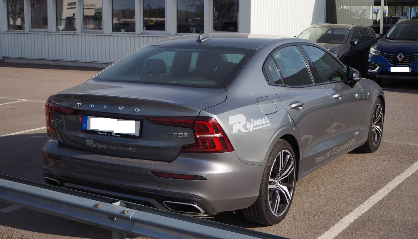 Rear of a modern sedan with LED taillights and dual exhaust