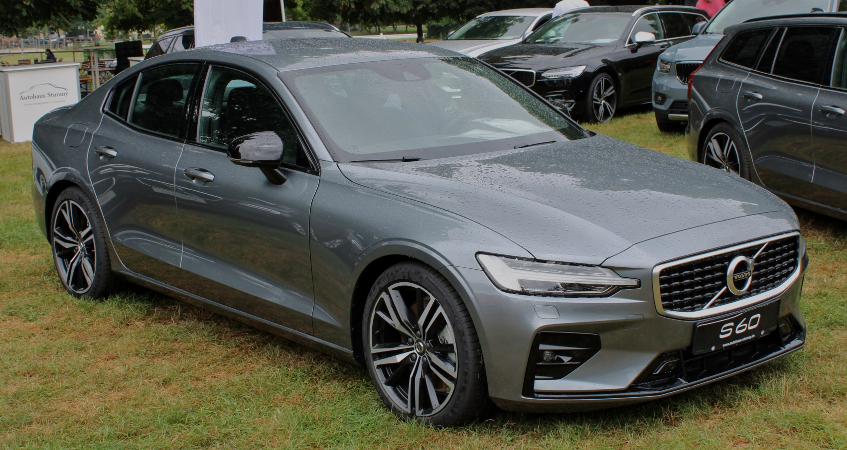 Silver sedan front three-quarter view with detailed grille and alloy wheels
