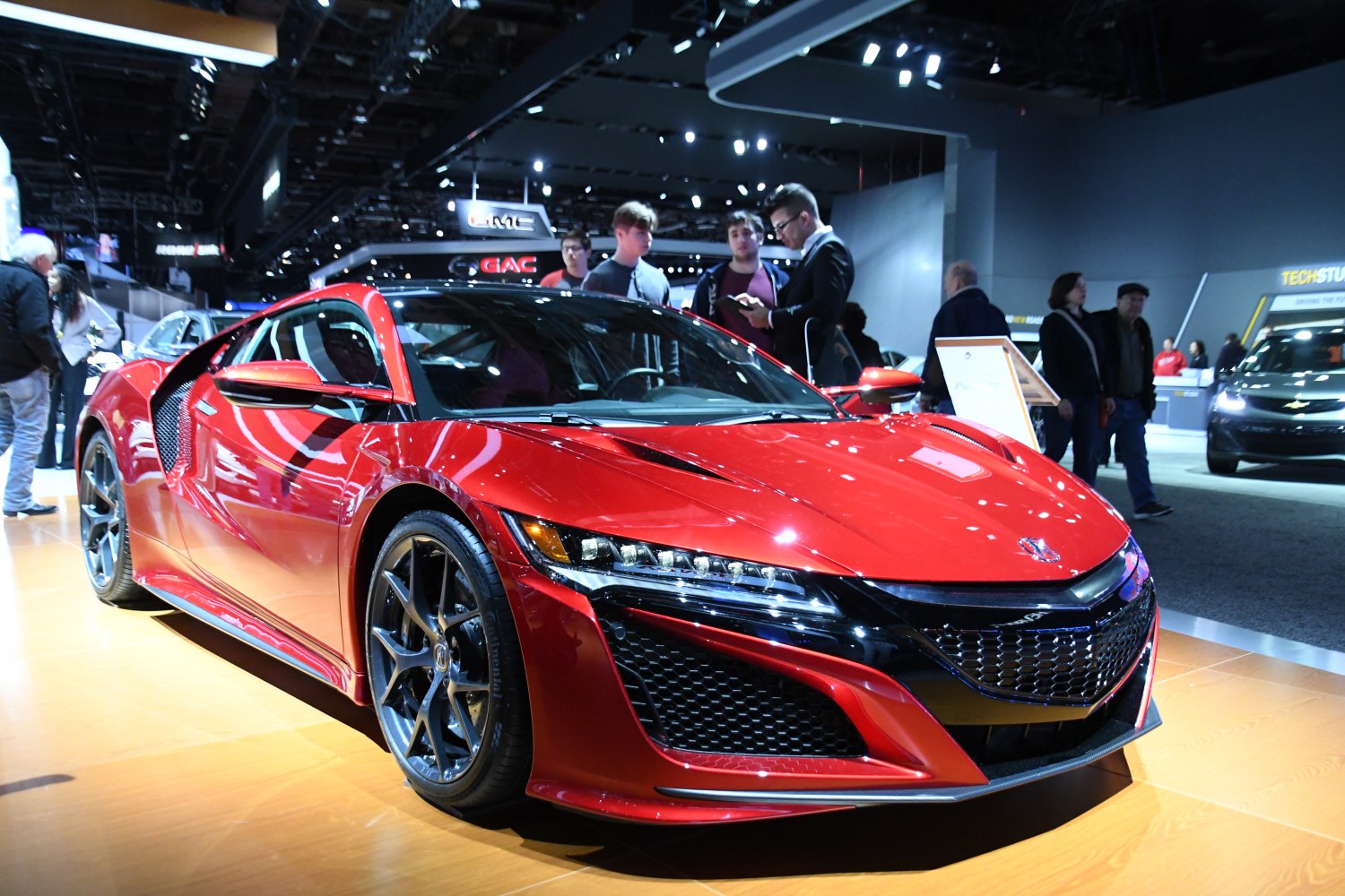 Red sports coupe with aggressive front and LED headlights