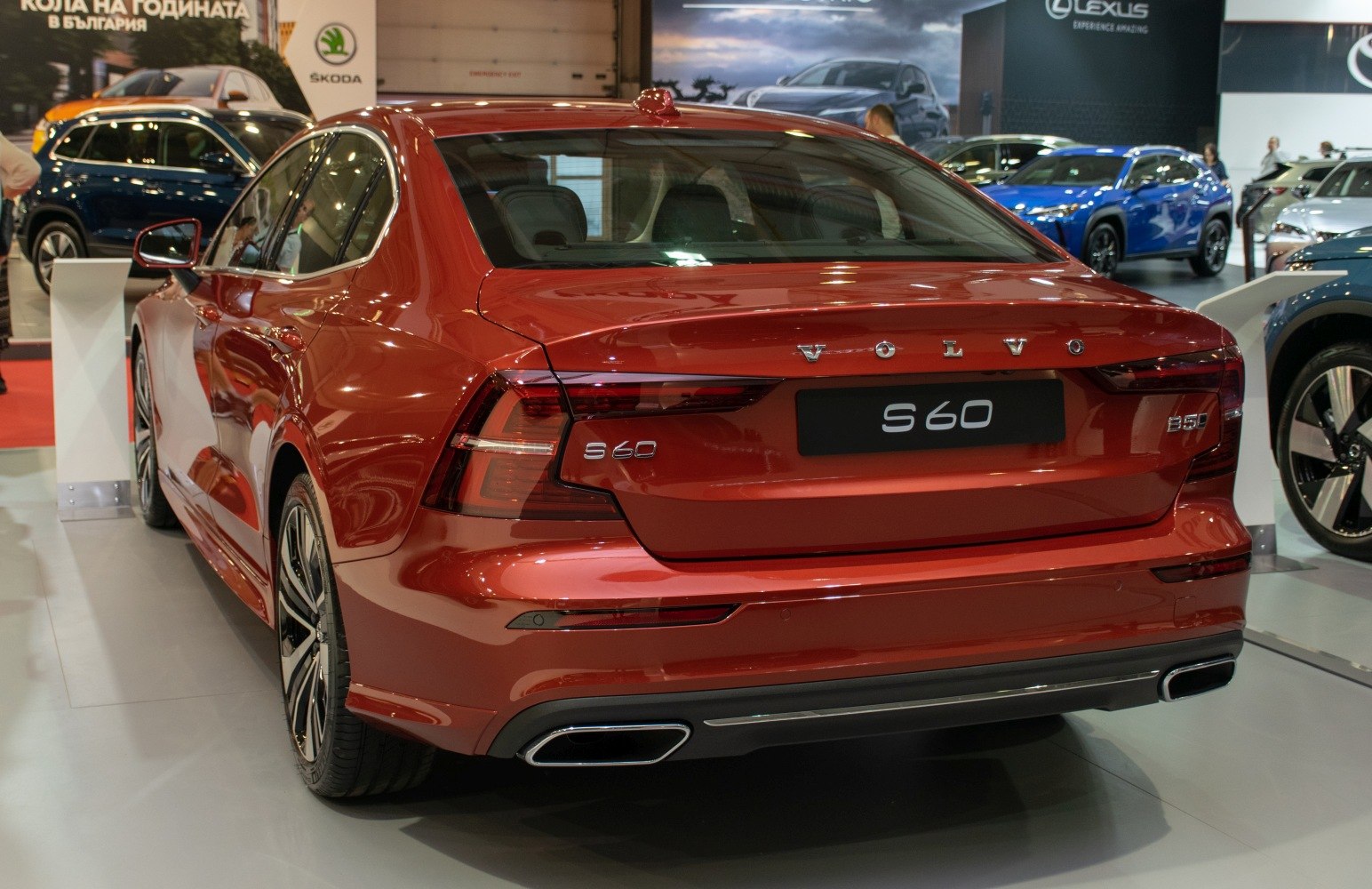 Rear view of a modern red sedan with distinctive tail lights and dual exhausts